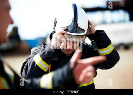 Firemen in discussion in training centre, Darlington, UK Stock Photo