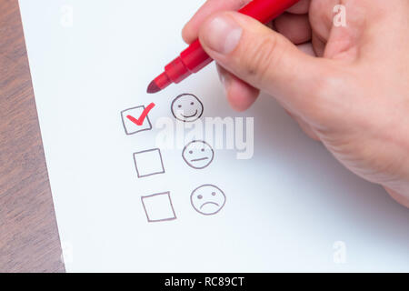 Human hand, tick placed on excellent check box. Customer service, satisfaction, survey form Stock Photo