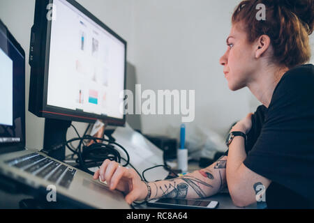 Fashion designer researching using digital tablet Stock Photo