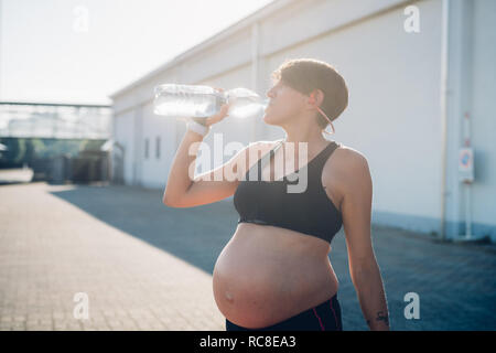 Pregnant woman having drink during workout Stock Photo