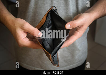 Businessman has no money. Unemployed and bankrupt man looks into his empty wallet. Stress crisis, unemployed businessmen waiting for new job Stock Photo