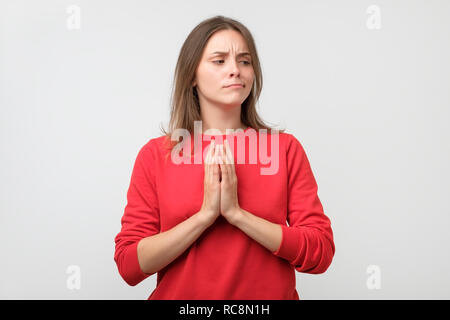 Young tricky woman having something in mind with sly facial expression Stock Photo