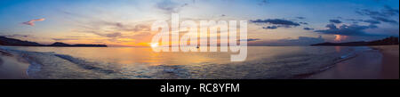 gold sunset over beach with wave splashes in summer of Thailand Stock Photo