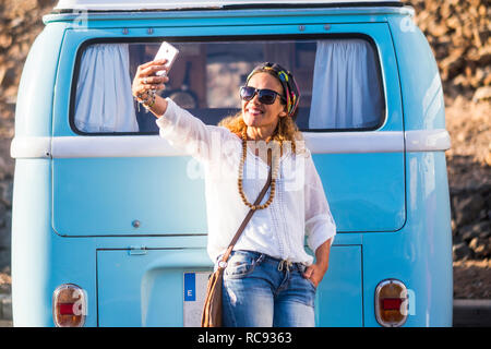 Cheerful caucasian 40 years old woman smile and take a selfie picture with phone cell - fashion trend happy people outdoor enjoying lifestyle - old vi Stock Photo