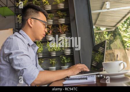 Young man studying on laptop Stock Photo