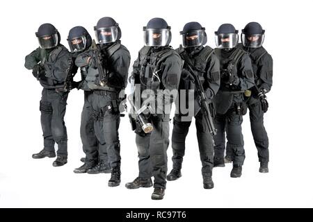 Police, Special Task Force, SEK, squad holding a metal battering ram and various weapons Stock Photo