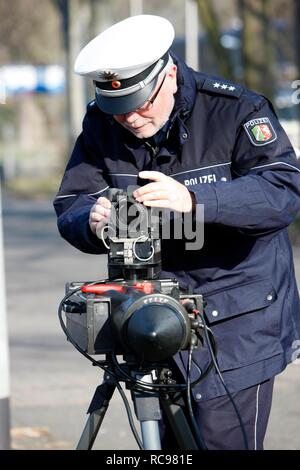 Police officer preparing a radar speed control camera, photocall, speed check marathon of the police in North Rhine-Westphalia Stock Photo