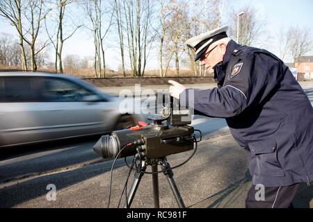 Police officer preparing a radar speed control camera, photocall, speed check marathon of the police in North Rhine-Westphalia Stock Photo