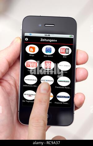 Iphone, smart phone, app on the screen, a virtual newsstand Stock Photo
