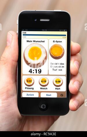 Iphone, smart phone, app on the screen, egg timer for different kinds of boiled eggs Stock Photo