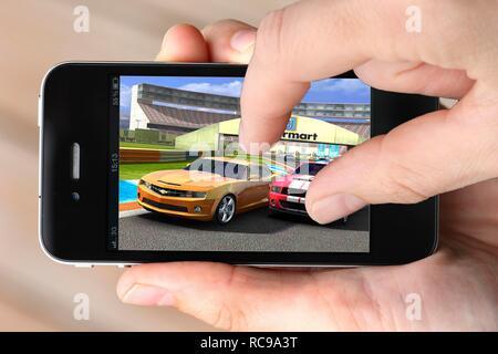 Iphone, smart phone, app on the screen, computer game, car racing Stock Photo