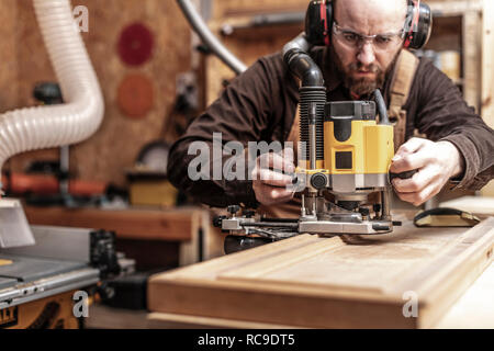 craftman portrait using a vertical router Stock Photo