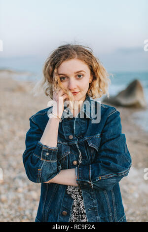 Blond haired young woman on beach, portrait, Menemsha, Martha's Vineyard, Massachusetts, USA Stock Photo