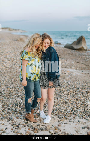 Two young women hugging on beach, Menemsha, Martha's Vineyard, Massachusetts, USA Stock Photo