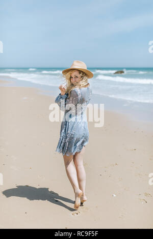 Barefoot young woman on windy beach, portrait, Menemsha, Martha's Vineyard, Massachusetts, USA Stock Photo
