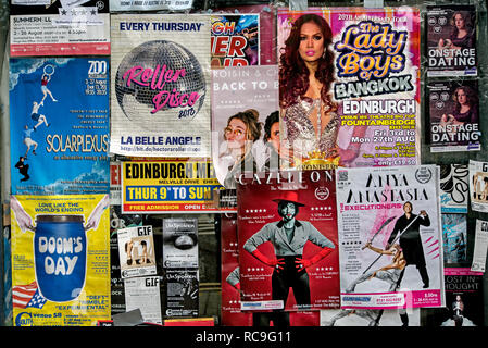 Posters stuck on the window of an empty shop advertising shows on the Edinburgh Fringe Festival, Edinburgh, Scotland, UK. Stock Photo