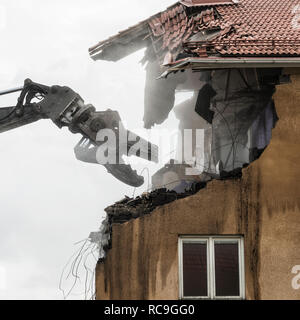 Machinery deconstructing old building Stock Photo - Alamy