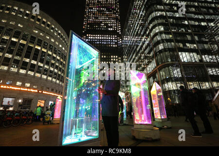 EDITORIAL USE ONLY Lewis Durkinn interacts with Prismatica by Raw Design at the annual Canary Wharf Winter Lights festival 2019, London. Stock Photo
