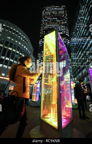 EDITORIAL USE ONLY Katherine Mielniczuk from Bristol interacts with Prismatica by Raw Design at the annual Canary Wharf Winter Lights festival 2019, London. Stock Photo