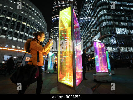 EDITORIAL USE ONLY Katherine Mielniczuk from Bristol interacts with Prismatica by Raw Design at the annual Canary Wharf Winter Lights festival 2019, London. Stock Photo