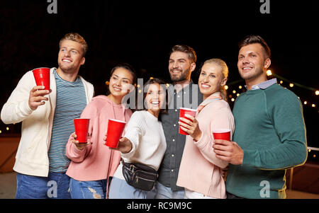 friends with drinks at rooftop party Stock Photo