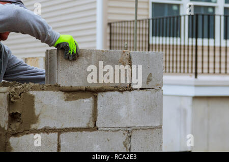 Plaster at construction masonry worker make concrete wall by cement block Stock Photo