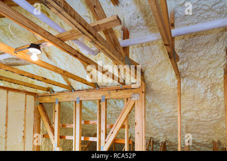 Foam plastic insulation installed in the sloping ceiling of a new frame house. Stock Photo