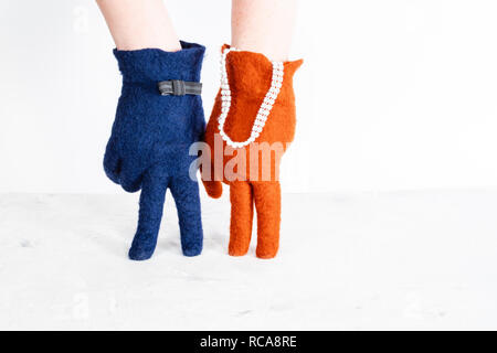 finger walking - hands in color felted gloves show lady and gentleman on date on white background Stock Photo