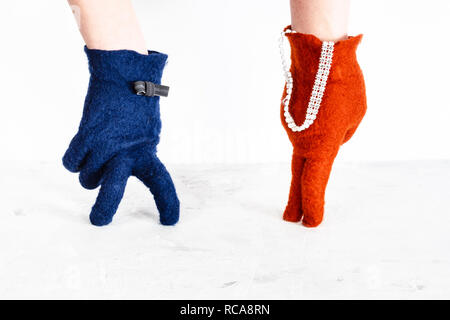finger walking - hands in color felted gloves show dancing lady and gentleman on white background Stock Photo