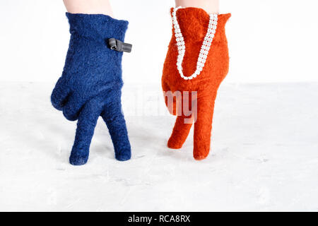 finger walking - hands in color felted gloves show walking couple on white background Stock Photo