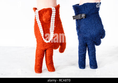 finger walking - hands in color felted gloves show speaking couple on white background Stock Photo