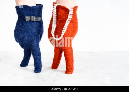 finger walking - hands in color felted gloves show walking lady and gentleman on white background Stock Photo