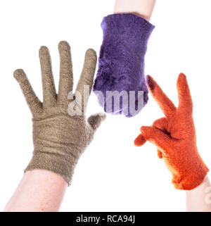 hands in woolen gloves show elements of rock-paper-scissors game isolated on white background Stock Photo