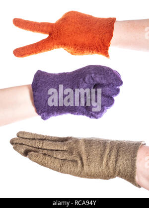 hands in felted gloves show elements of rock-paper-scissors game isolated on white background Stock Photo
