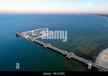 Sopot resort near Gdansk in Poland.  Wooden pier with harbor, marina with yachts and beach.  Aerial view in sunset light. Stock Photo