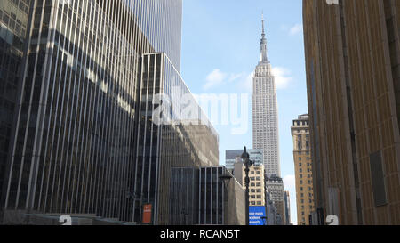 Empire State Building between Manhattan skyscrapers - NEW YORK / USA - DECEMBER 4, 2018 Stock Photo