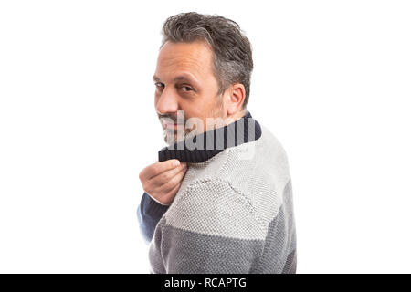 Man looking back as fixing collar getting ready with serious expression isolated on white Stock Photo