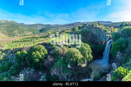 View of the Saar Waterfall, with Mount Hermon and Nimrod Fortress in the background, in the Golan Heights, Morthern Israel Stock Photo