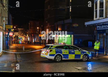 Ramsgate bomb suspected bomb incident on 14 January 2019. Police cars with blue flashing lights help cordon off the town centre, night time. Police car and policeman parked on main road leading to the centre of the town, city street. Stock Photo