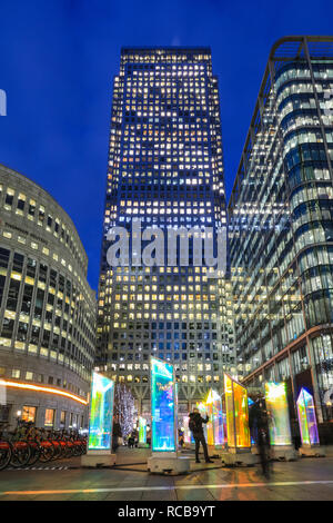 Canary Wharf, London, UK, 14th Jan 2019. People look at the revolving columns of the 'Prismatica' installation in Jubilee Square. The colourful Canary Wharf Winter Lights installations once again open to public viewing and interactive fun in and around Canary Wharf from Jan 15th until Jan 26th. Credit: Imageplotter News and Sports/Alamy Live News Stock Photo