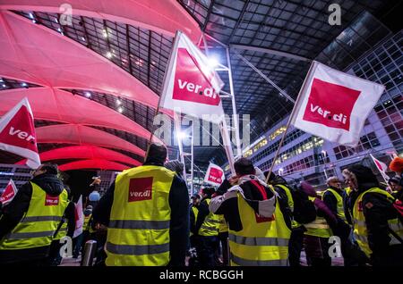 Munich, Bavaria, Germany. 15th Jan, 2019. The flags of the Verdi union representing the striking security workers at the Munich International Airport. Citing a breakdown in talks with employers on December 21st, the German Ver.di union organized the latest warning strike in a series at the Munich International Airport with members employed in Airport Security Services (Luftsicherheit) walking out from 3:30am to 24:00. The union is demanding 20 Euros per hour for their 23,000 total members working in Passenger-, Freight, Personnel, and Goods Control of Airport Security, along with recertif Stock Photo