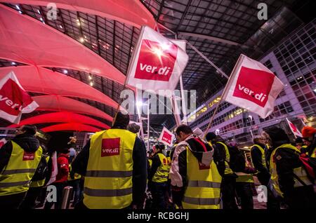 Munich, Bavaria, Germany. 15th Jan, 2019. The flags of the Verdi union representing the striking security workers at the Munich International Airport. Citing a breakdown in talks with employers on December 21st, the German Ver.di union organized the latest warning strike in a series at the Munich International Airport with members employed in Airport Security Services (Luftsicherheit) walking out from 3:30am to 24:00. The union is demanding 20 Euros per hour for their 23,000 total members working in Passenger-, Freight, Personnel, and Goods Control of Airport Security, along with recertif Stock Photo