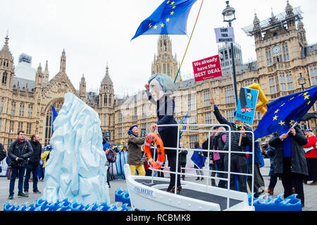 Westminster, London, UK. 15th Jan, 2019. A remain activist dresses up as Theresa May on the HMS Brexit, next to an iceberg and clutching a life ring with the words 'peoples vote' on it. (Outside parliament in the morning ahead of the crucial vote in the House of Commons of the EU Withdrawal Bill) Credit: Tom Leighton/Alamy Live News Stock Photo