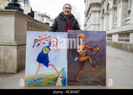 London, UK. 15th January, 2019. Satirical artist Kaya Mar stands outside Downing Street with paintings of Prime Minister Theresa May and Leader of the Opposition Jeremy Corbyn on the day of the vote in the House of Commons on Prime Minister Theresa May's proposed final Brexit withdrawal agreement. Credit: Mark Kerrison/Alamy Live News Stock Photo