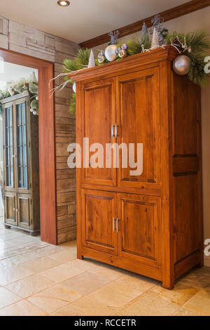 Old pinewood armoire in kitchen inside an old renovated circa 1840 Canadiana cottage style home Stock Photo