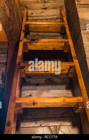 Pinewood Miller's stairs in attic bedroom leading to bed located on the mezzanine inside an old circa 1752 fieldstone home Stock Photo