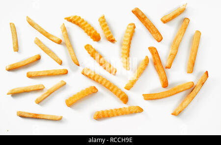 flat view of individual french fries in overhead view of ripple cut and oven chips Stock Photo