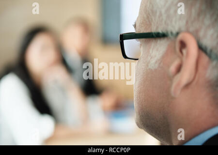 Businessman Talking To Colleagues and Clients In Office Meeting Room Stock Photo