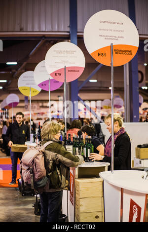 STRASBOURG, FRANCE - FEB 19, 2018: Woman buying French wine at the Vignerons independant English: Independent winemakers of France wine fair in Strasbourg Stock Photo