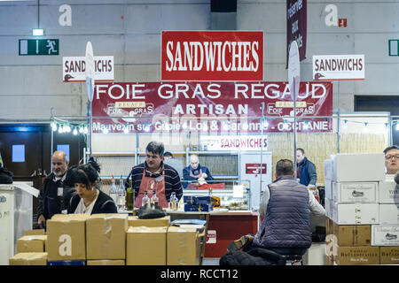 STRASBOURG, FRANCE - FEB 19, 2018: Customers tasting and buying French wine and foie gras at the Vignerons independant English: Independent winemakers of France wine fair  Stock Photo
